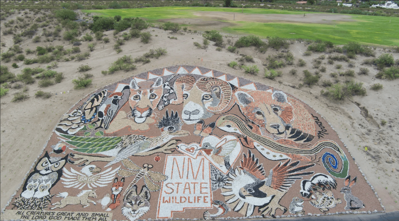 Wildlife mural on desert landscape with animals.