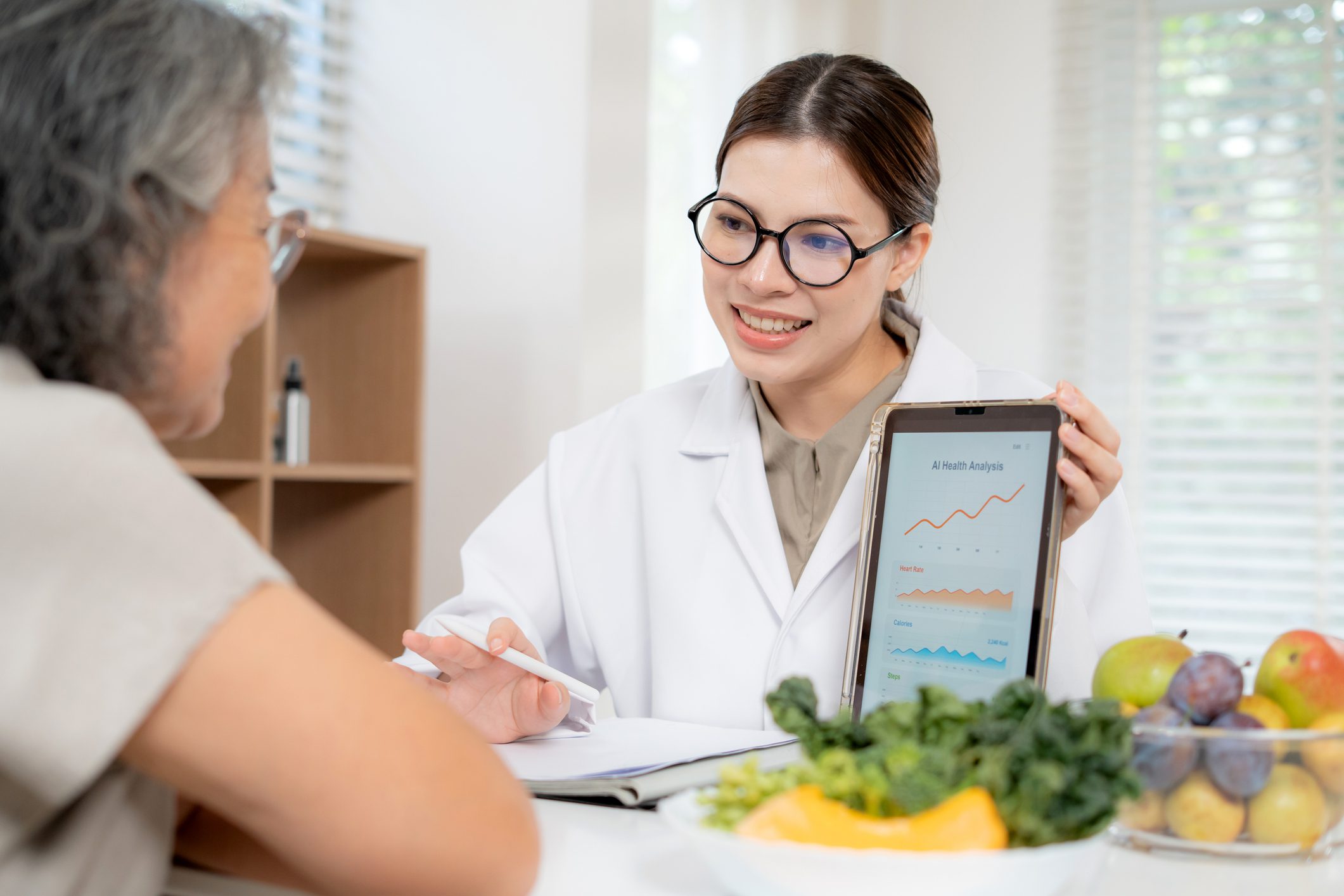 Nutritionist showing health charts to patient
